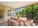 Screened porch with wood dining table and seating at 1085 Indian Rocks S Rd, Largo, FL 33770