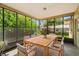 Screened porch with wood dining table and chairs at 1085 Indian Rocks S Rd, Largo, FL 33770