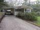 House exterior featuring a carport and well-maintained landscaping at 109 Florida Ave, Brooksville, FL 34601