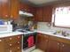 Bright kitchen with wood cabinets, gas stove, and microwave at 109 Florida Ave, Brooksville, FL 34601