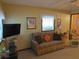 Living room with a sofa, armchair, and large windows at 109 Florida Ave, Brooksville, FL 34601