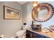 Stylish bathroom with copper sink, unique mirror, and granite vanity at 127 Sands Point Dr, Tierra Verde, FL 33715