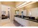 Double vanity bathroom with dark countertops and tiled floor at 127 Sands Point Dr, Tierra Verde, FL 33715