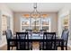 Formal dining room with hardwood floors and plantation shutters at 127 Sands Point Dr, Tierra Verde, FL 33715