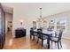 Bright dining room with chandelier, hardwood floors, and large windows at 127 Sands Point Dr, Tierra Verde, FL 33715