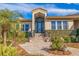 Inviting home exterior featuring a tiled walkway and lush landscaping at 127 Sands Point Dr, Tierra Verde, FL 33715