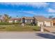 Single-story home with two-car garage and manicured lawn at 127 Sands Point Dr, Tierra Verde, FL 33715