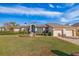 Single-story home with two-car garage, manicured lawn, and mature landscaping at 127 Sands Point Dr, Tierra Verde, FL 33715