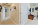 Bright hallway with neutral walls and carpeting at 127 Sands Point Dr, Tierra Verde, FL 33715