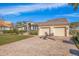 Stunning curb appeal, two-car garage, and lush landscaping at 127 Sands Point Dr, Tierra Verde, FL 33715