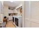 Laundry room with washer, dryer and storage at 127 Sands Point Dr, Tierra Verde, FL 33715