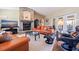 Bright living room featuring a large stone fireplace and leather sofas at 127 Sands Point Dr, Tierra Verde, FL 33715