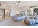 Spacious main bedroom with chaise lounge and ensuite bath at 127 Sands Point Dr, Tierra Verde, FL 33715