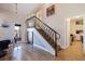 Stylish staircase with wrought-iron railing leading to upper level at 127 Sands Point Dr, Tierra Verde, FL 33715