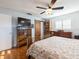 Spacious bedroom with wood floors and barn door at 1290 Cambridge Dr, Venice, FL 34293