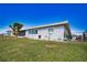 House exterior showcasing screened lanai and landscaping at 1290 Cambridge Dr, Venice, FL 34293