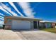 Single-story home with attached garage and well-maintained landscaping at 1290 Cambridge Dr, Venice, FL 34293