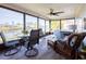 Relaxing sunroom with water views, wicker furniture, and spa at 1290 Cambridge Dr, Venice, FL 34293