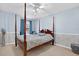 Bedroom with a four-poster bed and window seat at 1307 Timber Trace Dr, Wesley Chapel, FL 33543