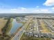 Aerial perspective of a residential area with houses and a pond at 14786 Horse Trot Rd, Lithia, FL 33547