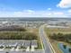 Aerial view of a residential neighborhood with houses, roads, and a lake at 14786 Horse Trot Rd, Lithia, FL 33547