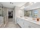 Double vanity bathroom with walk-in shower and access to the closet at 14786 Horse Trot Rd, Lithia, FL 33547