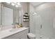 Clean bathroom with a walk-in shower, white vanity, and floating shelves at 14786 Horse Trot Rd, Lithia, FL 33547