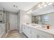 Modern bathroom with double sinks, a large mirror, and a walk-in shower at 14786 Horse Trot Rd, Lithia, FL 33547