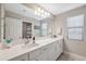 Double vanity bathroom with white cabinets and quartz countertops at 14786 Horse Trot Rd, Lithia, FL 33547