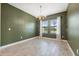 Dining room with green accent wall, chandelier and large windows at 14786 Horse Trot Rd, Lithia, FL 33547