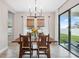 Bright dining room with wooden table and access to backyard at 14786 Horse Trot Rd, Lithia, FL 33547