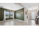 Dining room with green accent wall, chandelier, and tile floors at 14786 Horse Trot Rd, Lithia, FL 33547