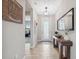 Bright entryway with wood console table, mirror, and modern light fixture at 14786 Horse Trot Rd, Lithia, FL 33547