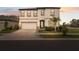 Two-story house with a white exterior, two-car garage, and landscaping at 14786 Horse Trot Rd, Lithia, FL 33547