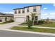 Two-story house with a white exterior, two-car garage, and landscaping at 14786 Horse Trot Rd, Lithia, FL 33547