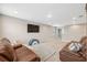 Bright game room with leather sofas, TV, and play area at 14786 Horse Trot Rd, Lithia, FL 33547