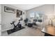 Home office with Peloton bike, desk, and window offering natural light at 14786 Horse Trot Rd, Lithia, FL 33547