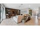 Open concept living room with comfortable seating and a wood feature wall at 14786 Horse Trot Rd, Lithia, FL 33547