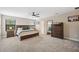 Main bedroom with a king-size bed, dresser, and walk-in closet at 14786 Horse Trot Rd, Lithia, FL 33547