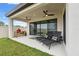 Relaxing patio with lounge chairs and ceiling fans at 14786 Horse Trot Rd, Lithia, FL 33547