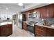 Well-equipped kitchen with stainless steel appliances and a view to the living room at 1600 Gulf Blvd # 417, Clearwater Beach, FL 33767
