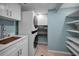 Convenient laundry room with washer, dryer and shelving at 1600 Gulf Blvd # 417, Clearwater Beach, FL 33767
