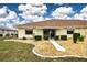 Landscaped backyard with walkway and patio at 1613 Faxton Dr, Sun City Center, FL 33573