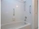 Bathroom with shower, grab bars, and tiled walls at 1613 Faxton Dr, Sun City Center, FL 33573