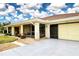 Bright yellow garage door and covered entryway at 1613 Faxton Dr, Sun City Center, FL 33573