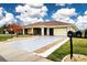 Single-story home with attached garage and landscaped yard at 1613 Faxton Dr, Sun City Center, FL 33573