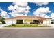 House exterior featuring a landscaped lawn at 1613 Faxton Dr, Sun City Center, FL 33573