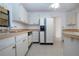 Bright kitchen with white cabinets and tile floors at 1613 Faxton Dr, Sun City Center, FL 33573