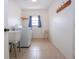 Laundry room with washer, dryer, utility sink and built-in shelving at 1613 Faxton Dr, Sun City Center, FL 33573