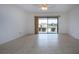 Bright living room with tile floors and sliding glass doors leading to patio at 1613 Faxton Dr, Sun City Center, FL 33573